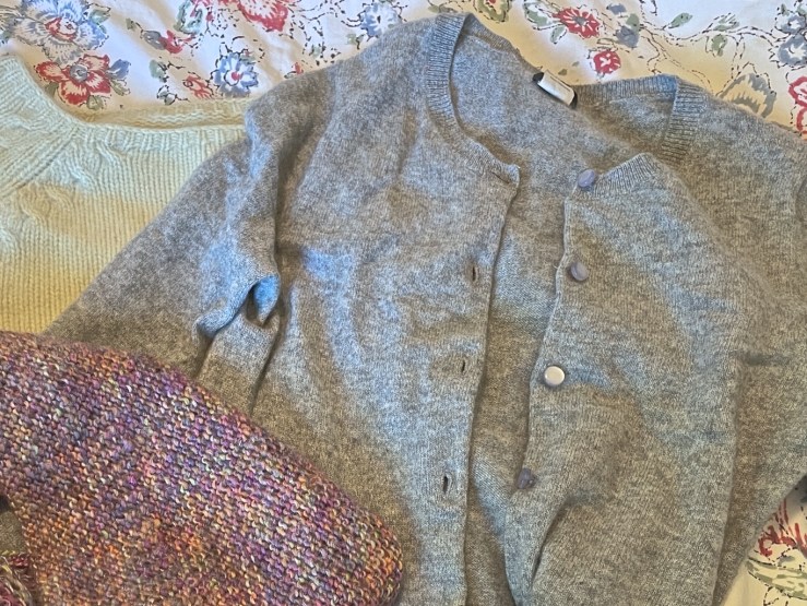 Photo of two sweaters and a scarf bought at the thrift store