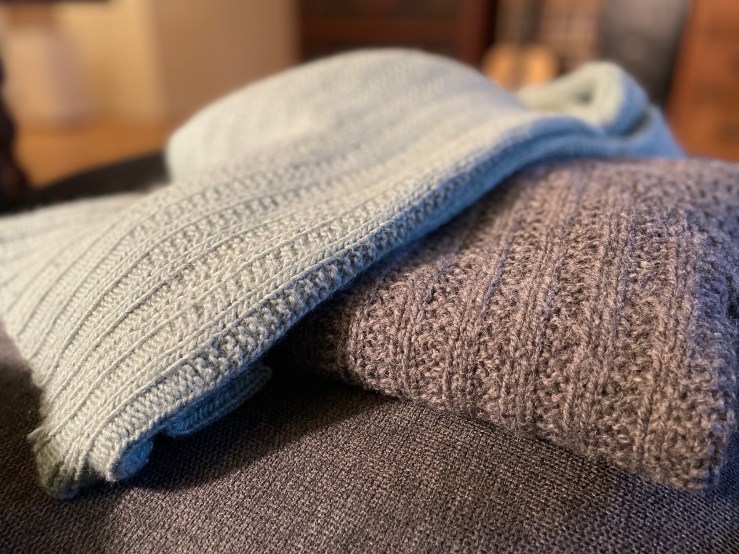 Close up of stitch gauges of lighter blue jacket and heavier gray jacket