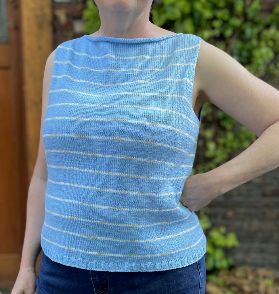 Coolsville sleeveless top in sky blue with thin white stripes.