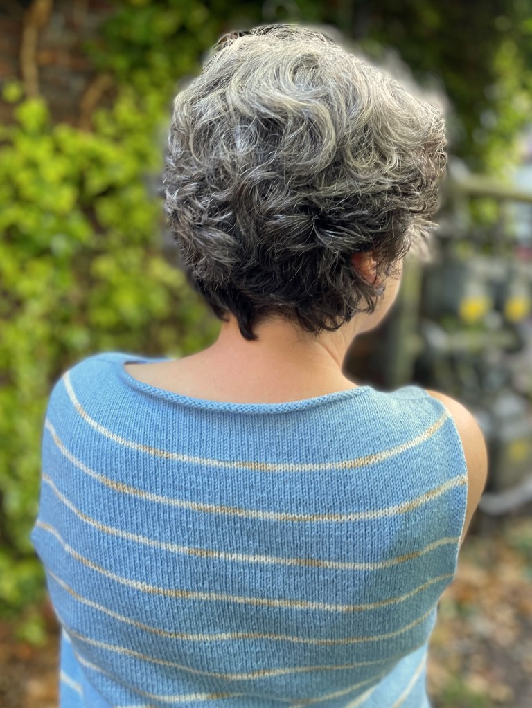 Coolsville sleeveless top in sky blue with thin white stripes.